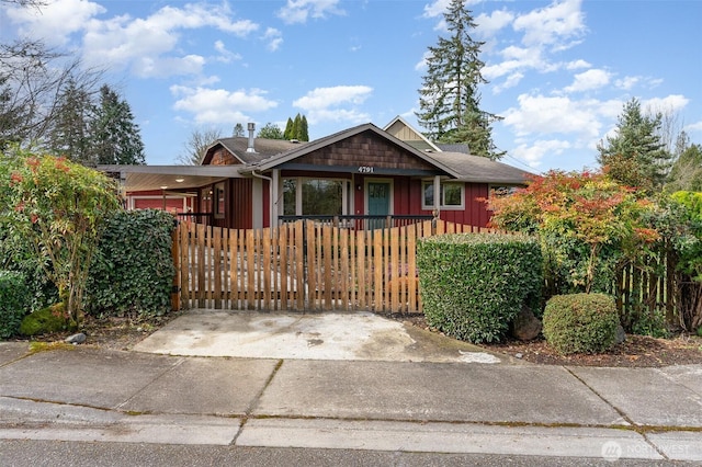 view of front of property featuring board and batten siding and a fenced front yard