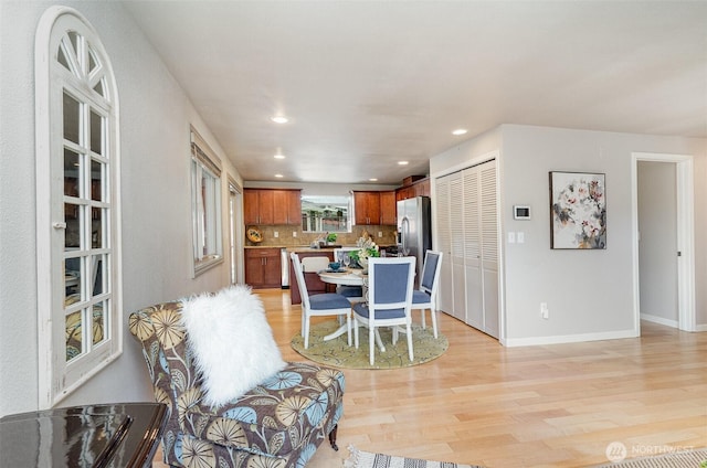 dining room featuring recessed lighting, light wood-type flooring, and baseboards