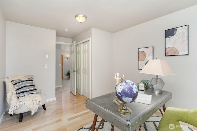 office with light wood-style flooring and baseboards