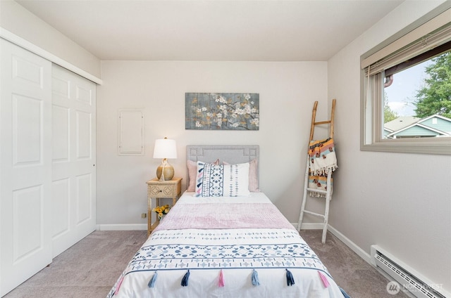 carpeted bedroom featuring baseboards and a baseboard radiator