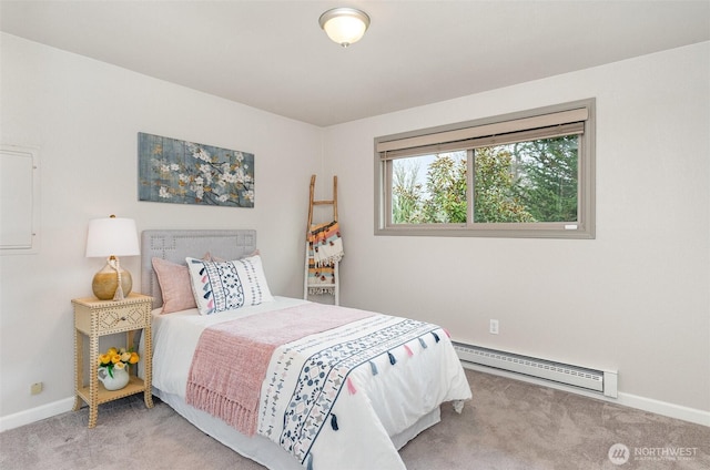 carpeted bedroom with a baseboard heating unit and baseboards