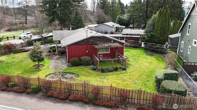 view of home's exterior with a lawn and a fenced front yard