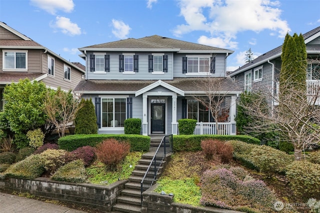 view of front of property featuring a shingled roof