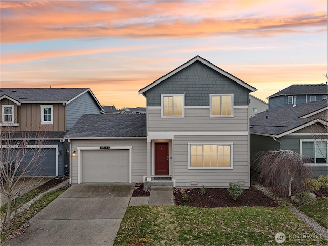 traditional home with a garage, concrete driveway, and a yard