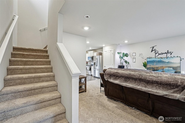 bedroom with carpet, recessed lighting, and stainless steel fridge with ice dispenser