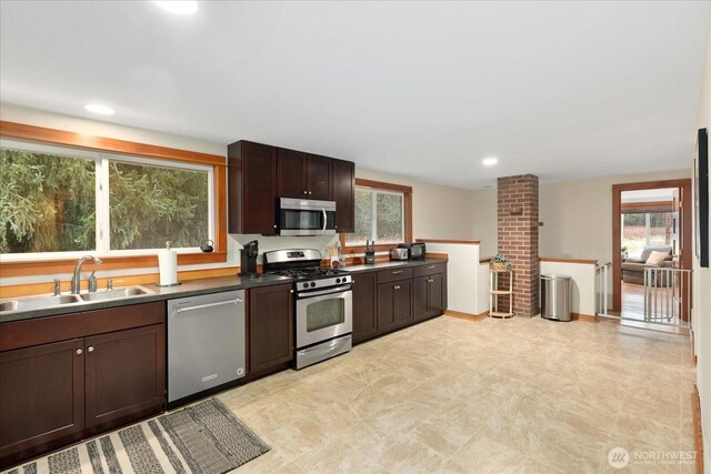 kitchen with stainless steel appliances, recessed lighting, a sink, and dark brown cabinets