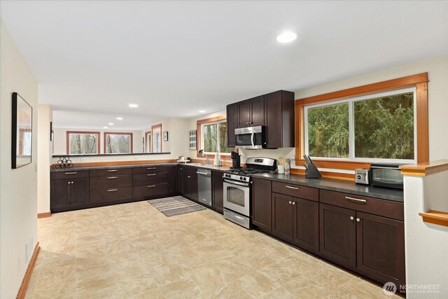 kitchen with dark brown cabinetry, visible vents, stainless steel appliances, and recessed lighting