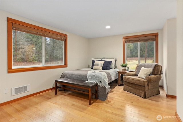 bedroom featuring recessed lighting, wood-type flooring, visible vents, and baseboards