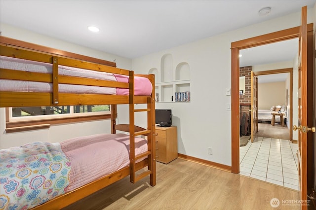 bedroom featuring baseboards and light wood finished floors