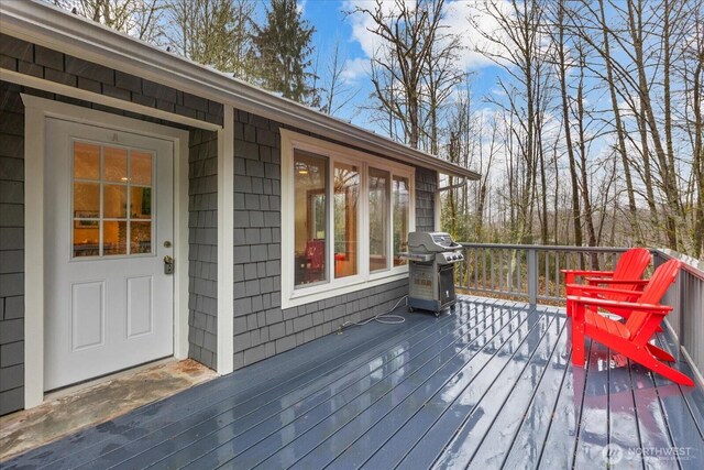 wooden deck with area for grilling