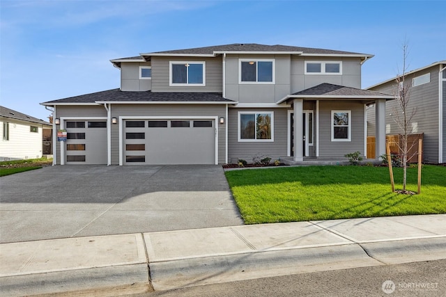 prairie-style home with a front yard and a garage