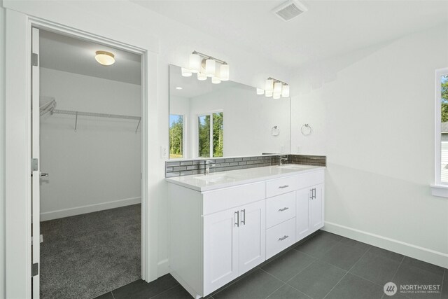 5846 229th Ave E, Buckley, WA 98321 - full bath with double vanity, healthy amount of natural light, a walk in closet, and tile patterned floors