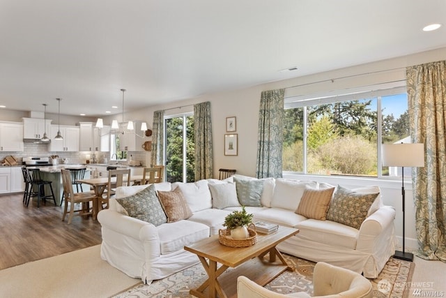 living room featuring hardwood / wood-style floors and a notable chandelier