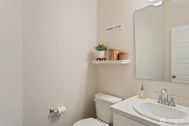 bathroom featuring toilet and vanity