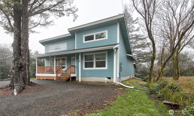 view of front of property featuring gravel driveway and covered porch