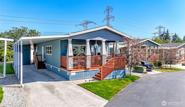 view of front of house with a porch, a front lawn, and a carport