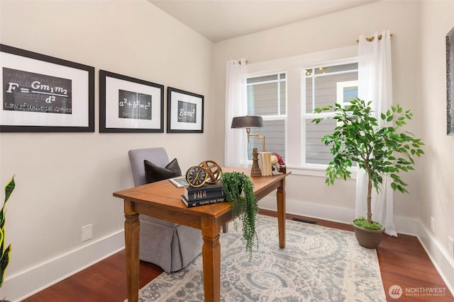 home office with visible vents, baseboards, and wood finished floors