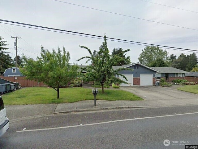 view of front of property with a front lawn and a garage