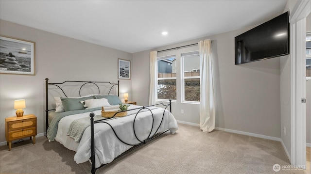 bedroom featuring recessed lighting, light colored carpet, and baseboards