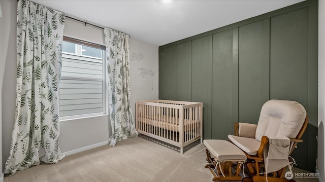 bedroom featuring a crib and light colored carpet