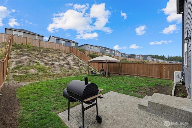 view of yard with ac unit, a patio area, a fenced backyard, and a residential view