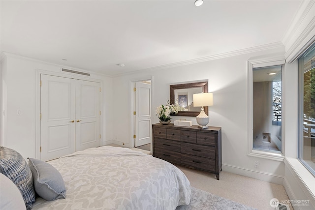 carpeted bedroom with a closet and ornamental molding