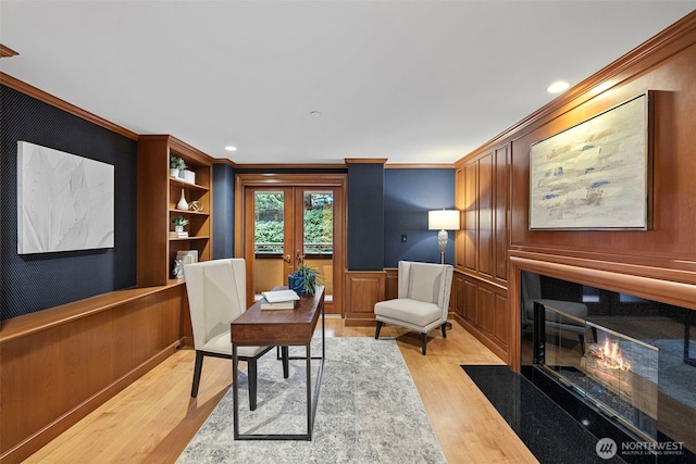 office featuring light wood-type flooring, french doors, and crown molding