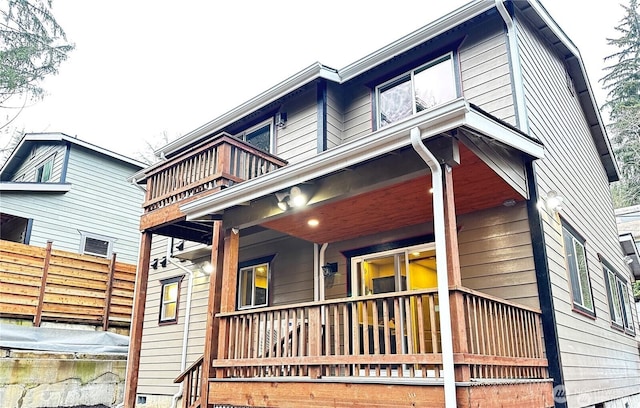 view of side of home featuring a balcony