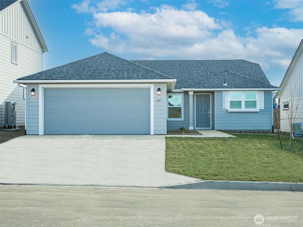 view of front of home with a garage and a front yard