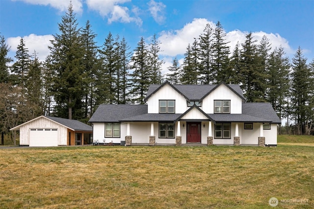 modern farmhouse featuring a garage, an outbuilding, a porch, and a front lawn