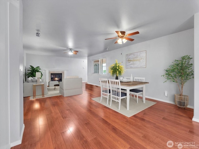 dining area with hardwood / wood-style flooring and ceiling fan