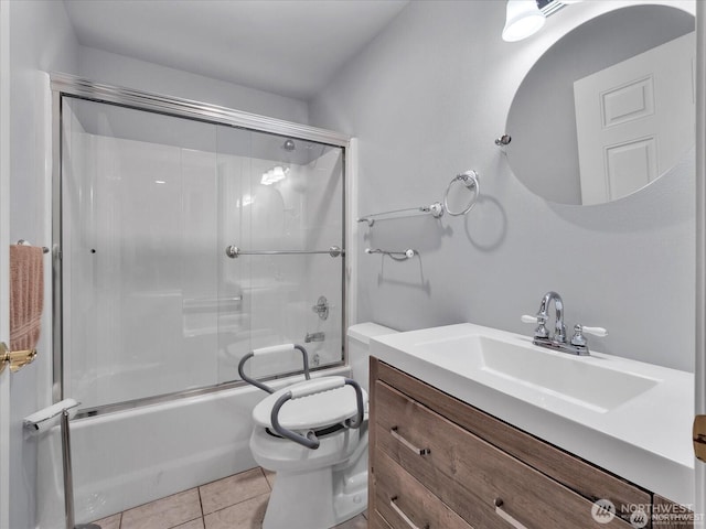 full bathroom with tile patterned floors, vanity, combined bath / shower with glass door, and toilet