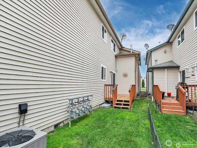 view of yard featuring central AC unit and a deck