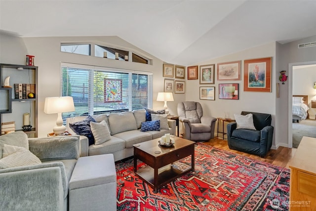 living room with vaulted ceiling and hardwood / wood-style floors