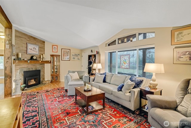 living room featuring a fireplace, vaulted ceiling, and hardwood / wood-style floors