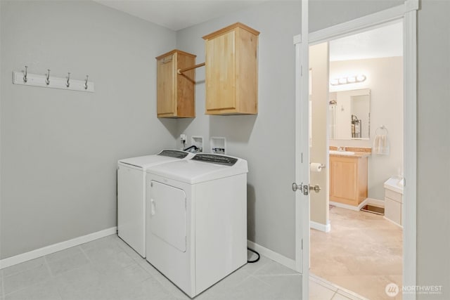 laundry area featuring cabinets and washer and clothes dryer