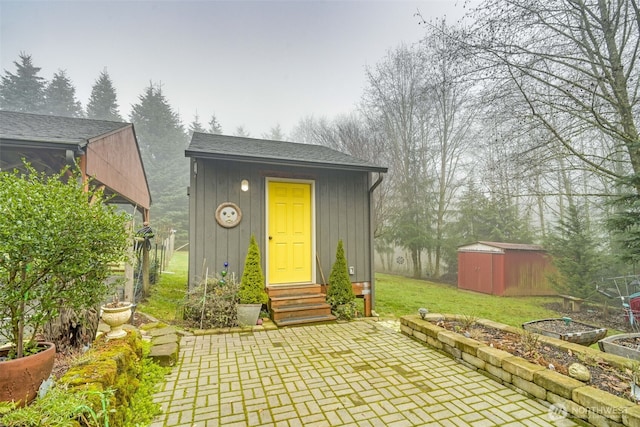 view of outbuilding featuring a lawn