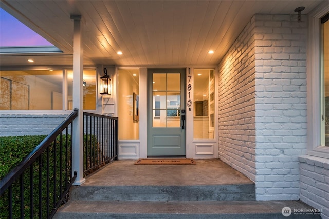 exterior entry at dusk with brick siding