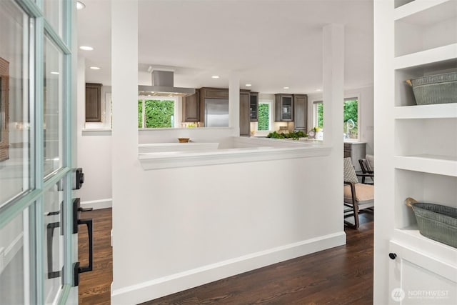 foyer featuring dark wood-style flooring, recessed lighting, and baseboards