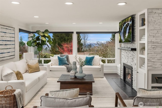 sunroom / solarium featuring a fireplace