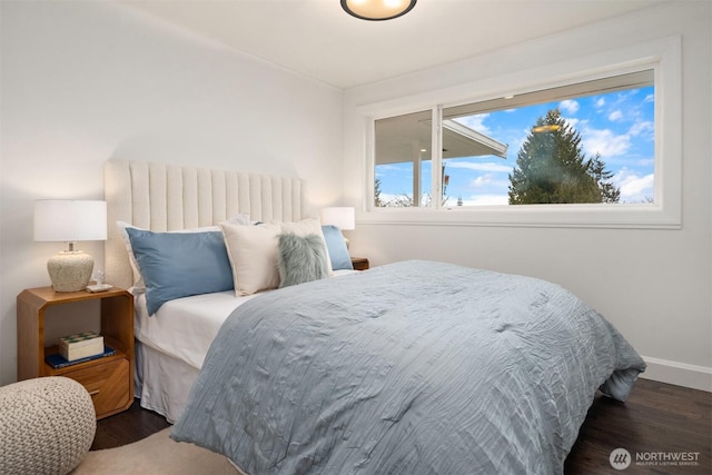 bedroom with dark wood-style floors and baseboards