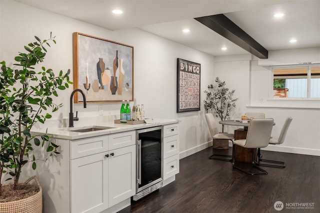 bar featuring dark wood finished floors, wine cooler, wet bar, a sink, and recessed lighting