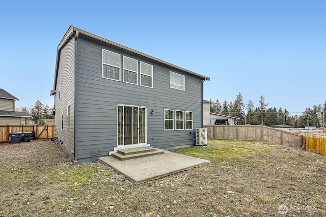 back of property with a yard and a patio area