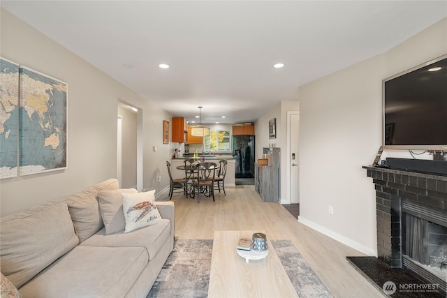 living room with a fireplace and light hardwood / wood-style floors