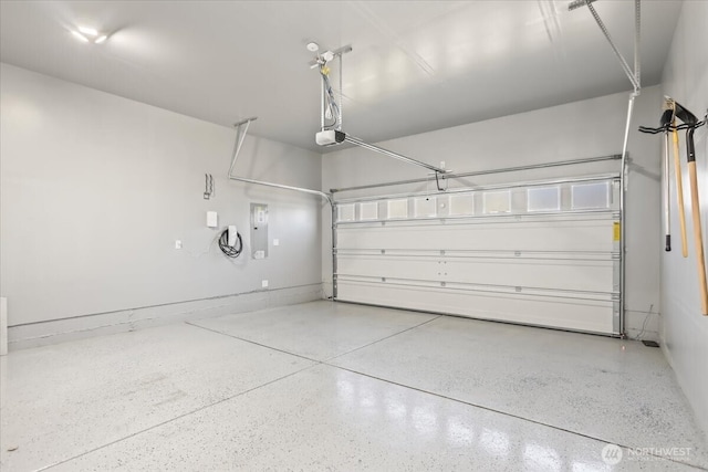 garage featuring electric panel and a garage door opener