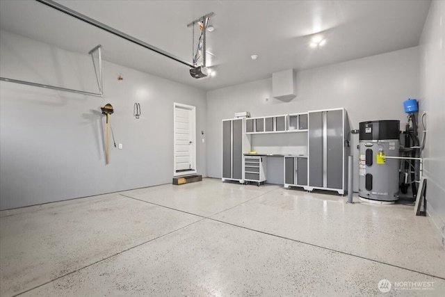 garage featuring water heater and a garage door opener