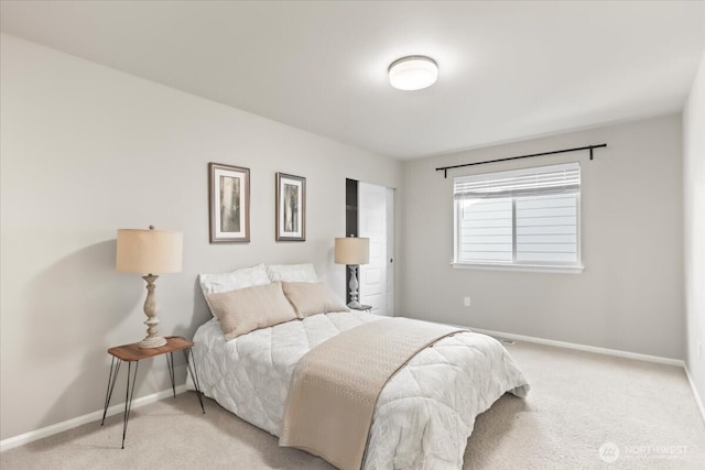 bedroom with baseboards and light colored carpet