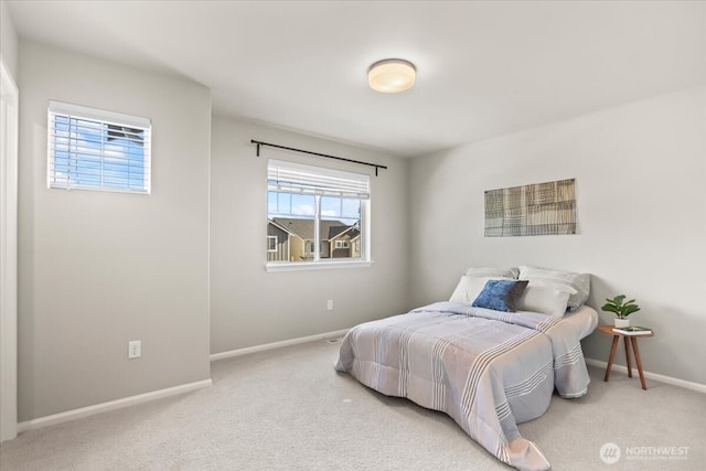 carpeted bedroom featuring baseboards