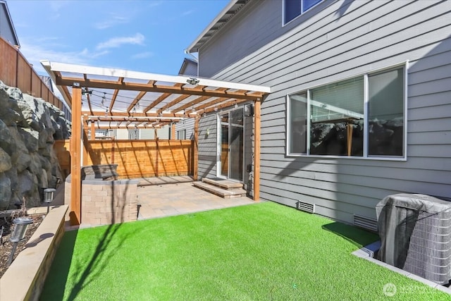 view of yard featuring a patio, central air condition unit, fence, and a pergola