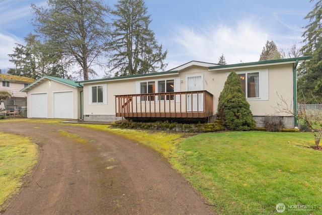 ranch-style house with a front yard, crawl space, a deck, a garage, and driveway